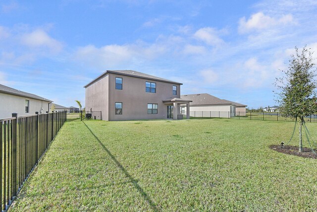 back of house featuring a yard