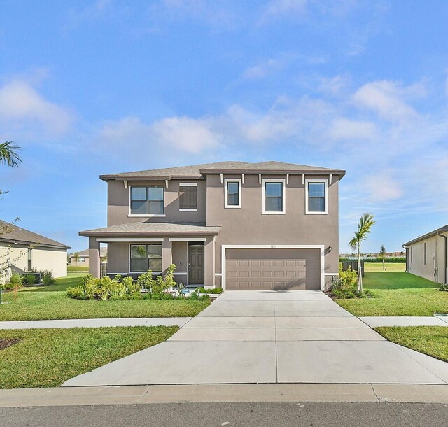 view of front of home with a garage and a front lawn