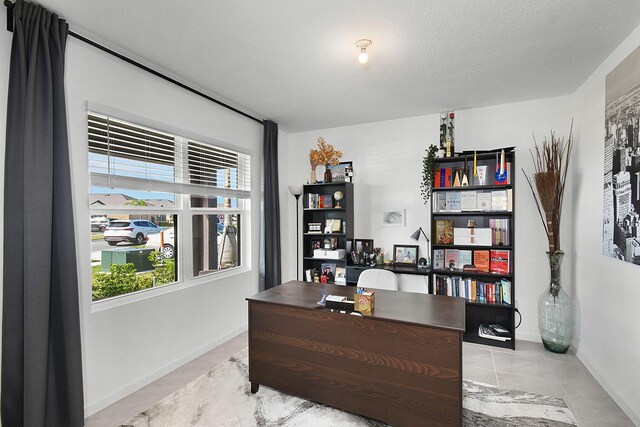 tiled office with a textured ceiling