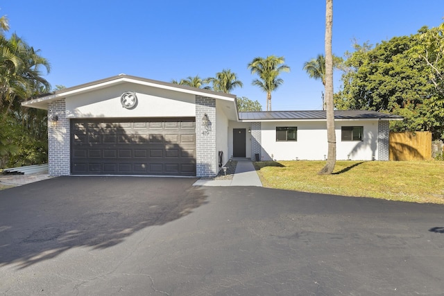 ranch-style house with a front yard and a garage