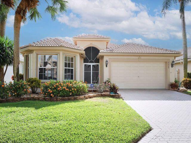 mediterranean / spanish home with a front yard and a garage