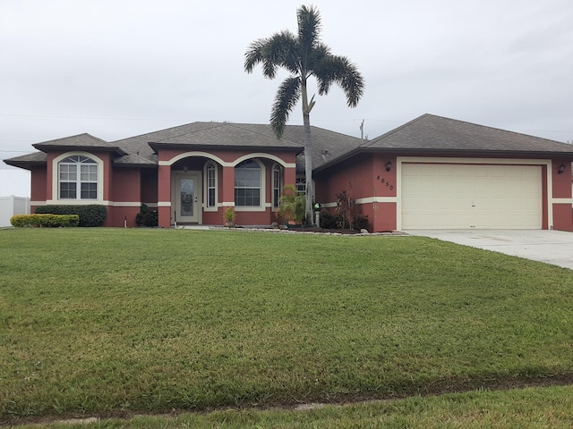 view of front of property with a front lawn and a garage