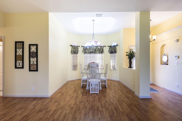 dining room featuring dark hardwood / wood-style flooring and a chandelier