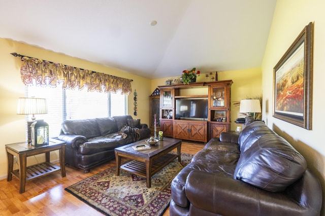 living room featuring hardwood / wood-style flooring and lofted ceiling