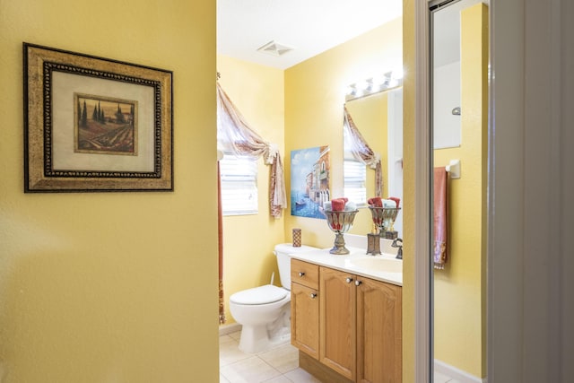 bathroom with tile patterned flooring, vanity, and toilet