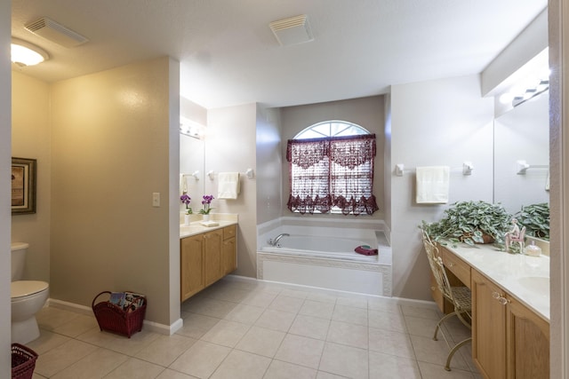 bathroom with tile patterned flooring, vanity, toilet, and a bathing tub