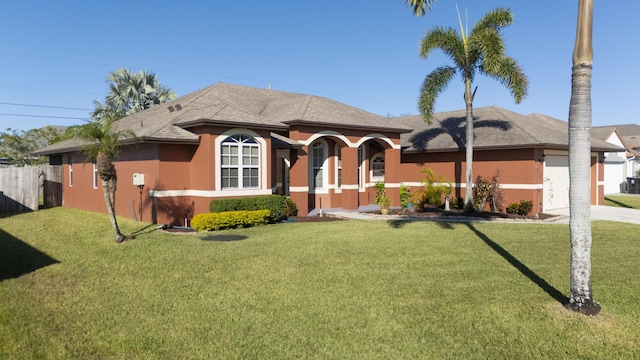 view of front facade featuring a garage and a front lawn