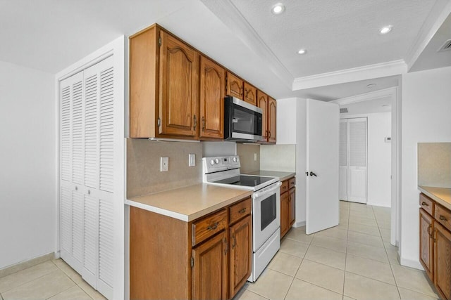 kitchen with decorative backsplash, a textured ceiling, crown molding, light tile patterned floors, and electric range