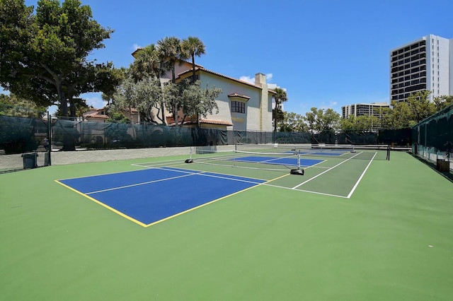 view of tennis court with basketball hoop