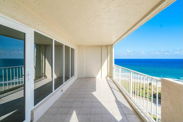 balcony with a view of the beach and a water view