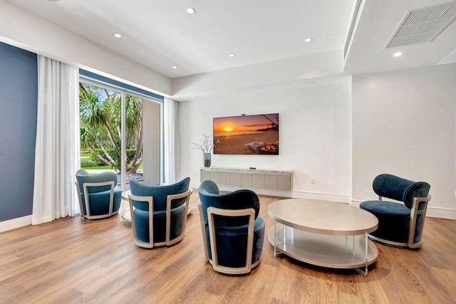 sitting room with wood-type flooring