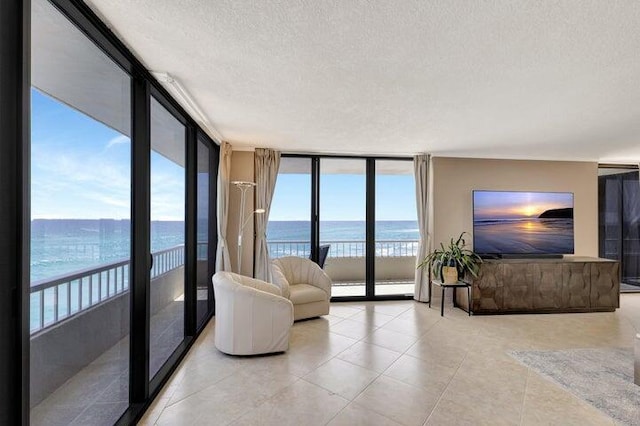 living room featuring plenty of natural light, expansive windows, and a textured ceiling