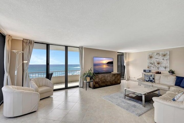 living room with a textured ceiling and floor to ceiling windows