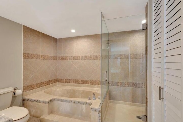 bathroom featuring tile patterned flooring, shower with separate bathtub, and toilet