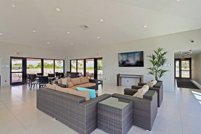 living room featuring french doors and light tile patterned flooring