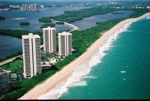 drone / aerial view featuring a beach view and a water view