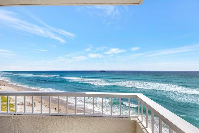 balcony with a view of the beach and a water view