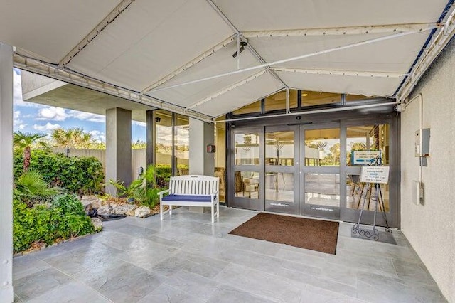 unfurnished sunroom featuring vaulted ceiling