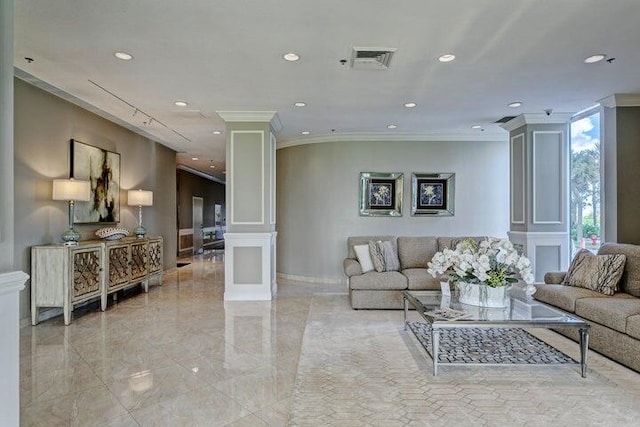 living room featuring ornate columns and ornamental molding