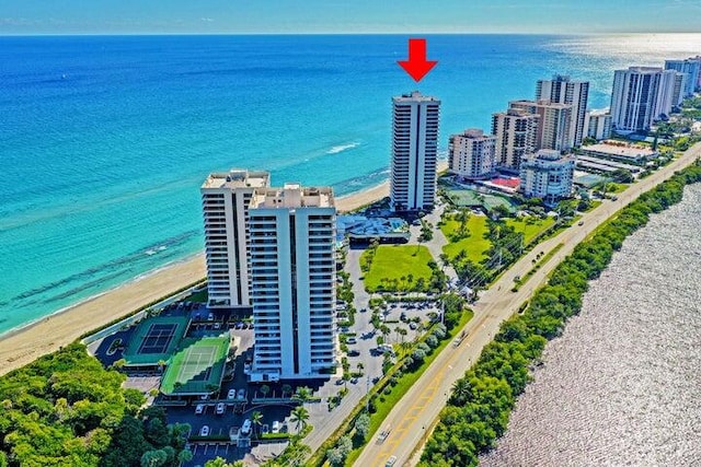 birds eye view of property with a water view and a view of the beach