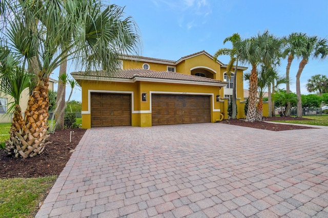 mediterranean / spanish home featuring a garage