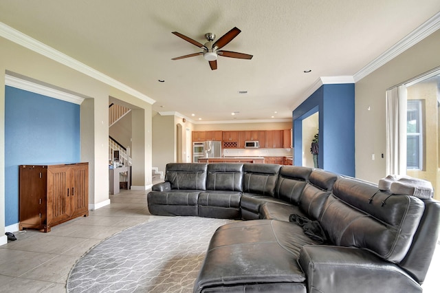 tiled living room featuring ceiling fan and ornamental molding