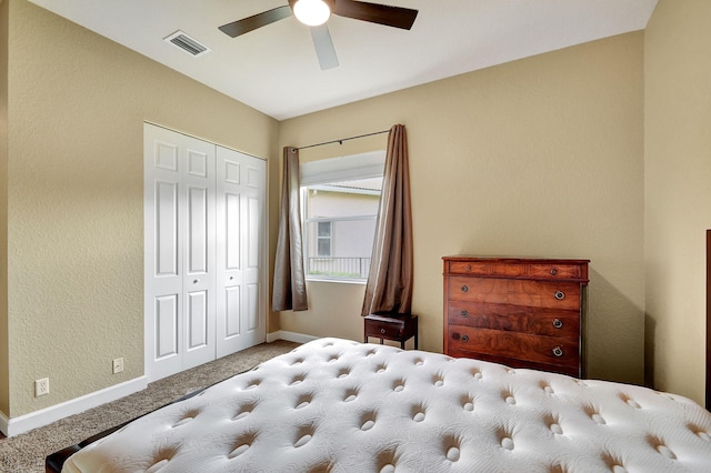 carpeted bedroom with ceiling fan and a closet