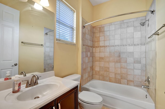 full bathroom featuring toilet, vanity, and tiled shower / bath