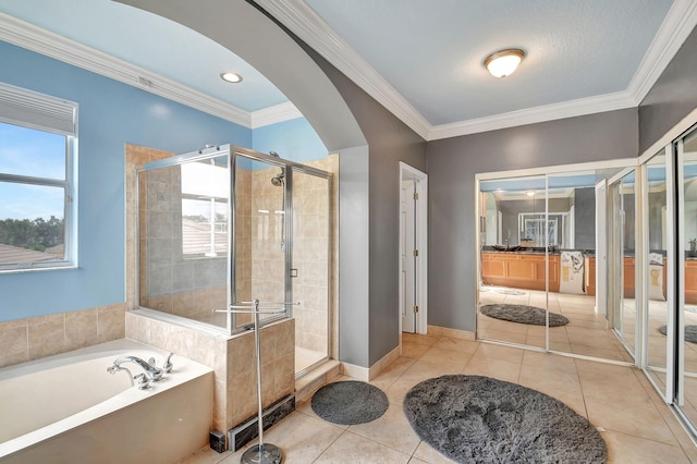 bathroom with tile patterned floors, crown molding, and plus walk in shower