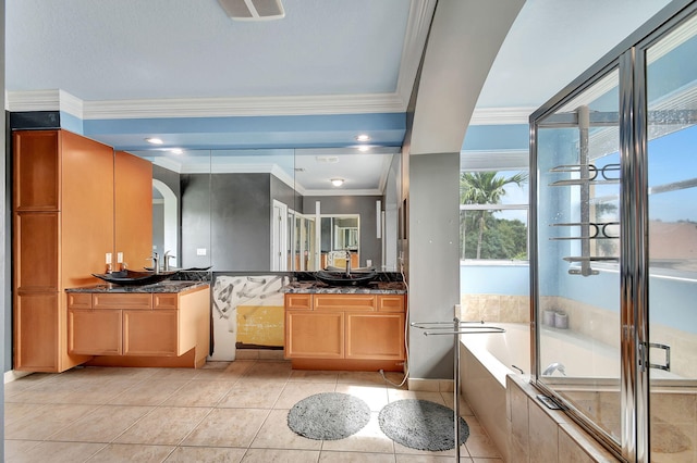 bathroom with tile patterned flooring, vanity, a wealth of natural light, and ornamental molding