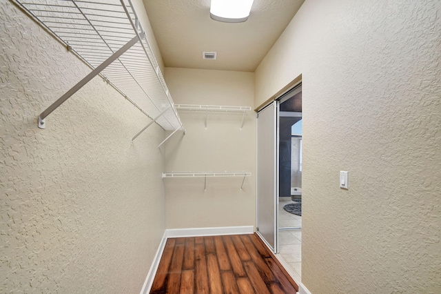 walk in closet featuring hardwood / wood-style flooring