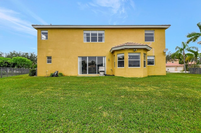 rear view of house featuring a lawn