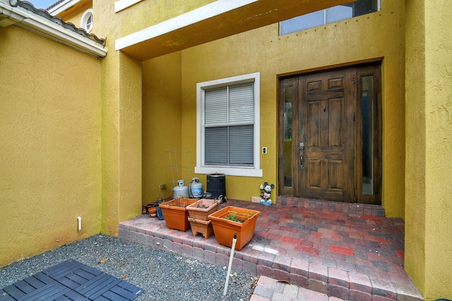 entrance to property featuring a patio