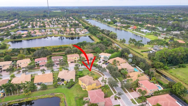 birds eye view of property with a water view