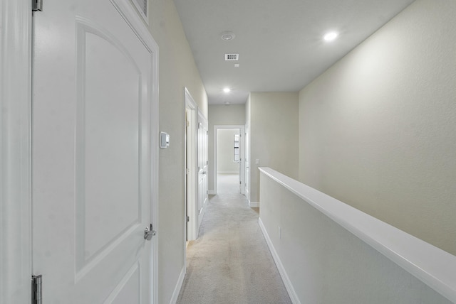 hallway with visible vents, light carpet, an upstairs landing, recessed lighting, and baseboards