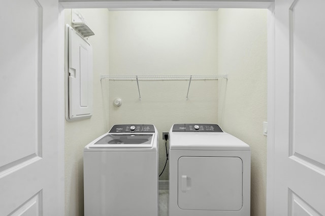 washroom featuring laundry area and washing machine and clothes dryer