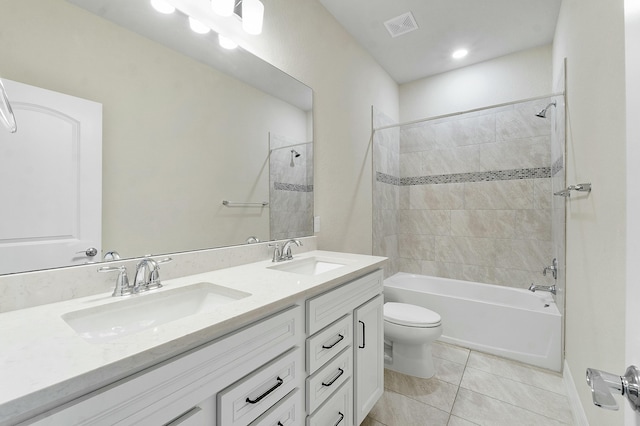 full bathroom with tile patterned flooring, vanity, toilet, and tiled shower / bath