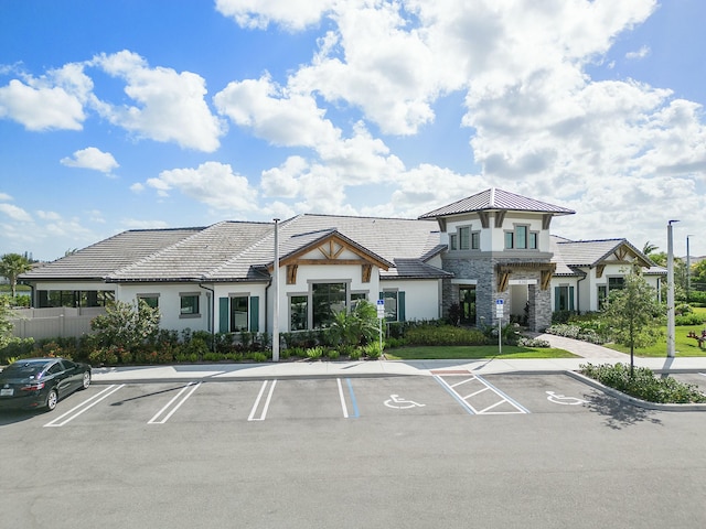 view of building exterior featuring uncovered parking and fence