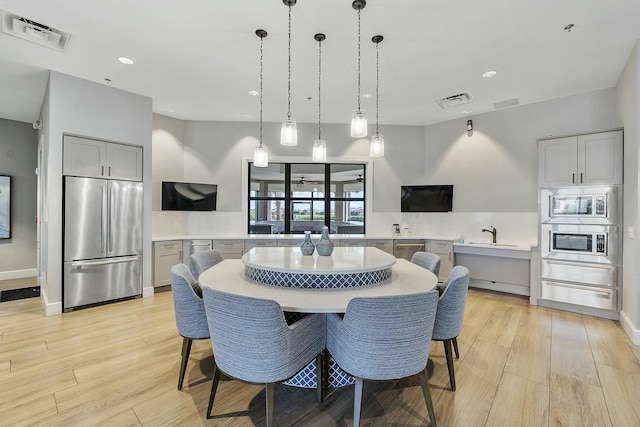 dining area with recessed lighting, visible vents, and light wood finished floors