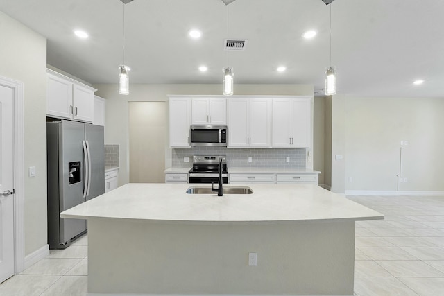 kitchen featuring visible vents, stainless steel appliances, light countertops, and a sink