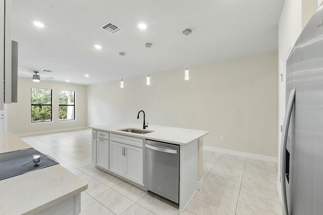 kitchen with pendant lighting, white cabinets, sink, ceiling fan, and stainless steel appliances