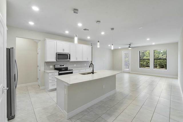 kitchen featuring stainless steel appliances, ceiling fan, sink, decorative light fixtures, and white cabinetry