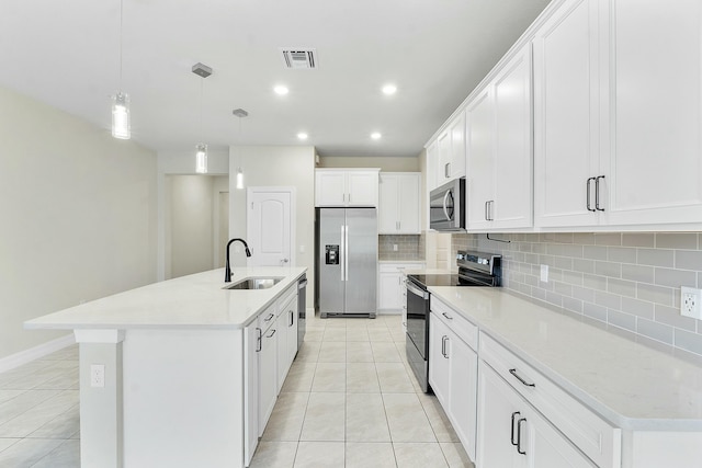 kitchen featuring light tile patterned floors, visible vents, appliances with stainless steel finishes, and a sink