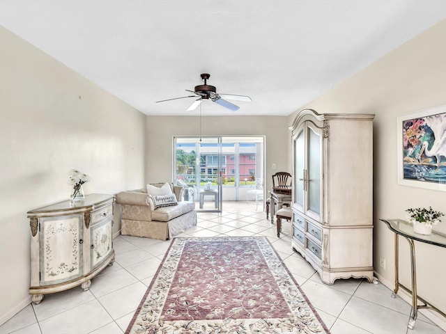 living room featuring ceiling fan and light tile patterned flooring