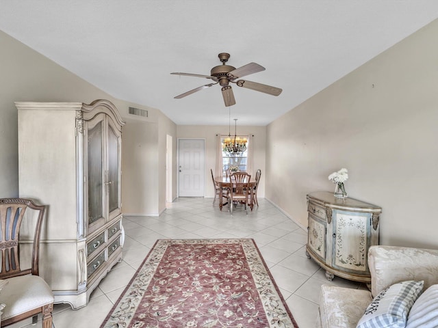 living room with ceiling fan with notable chandelier and light tile patterned flooring