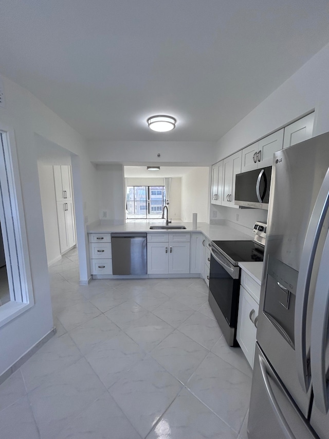 kitchen featuring white cabinetry and tile walls