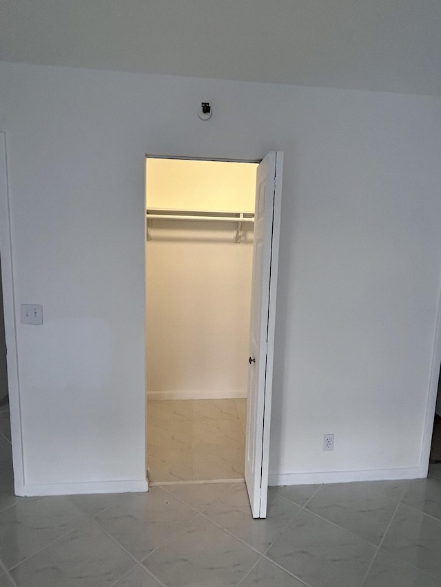 unfurnished bedroom featuring tile patterned floors and a closet