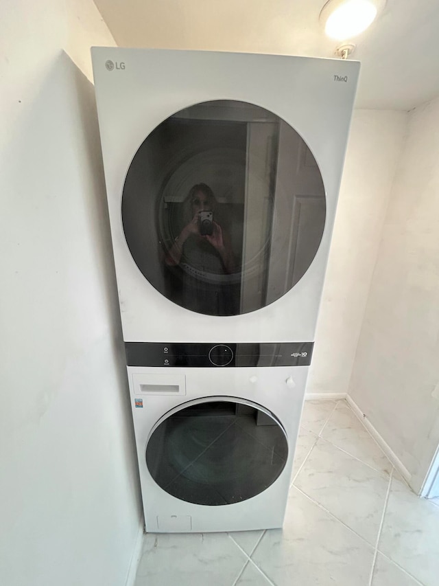 laundry area featuring stacked washer / dryer