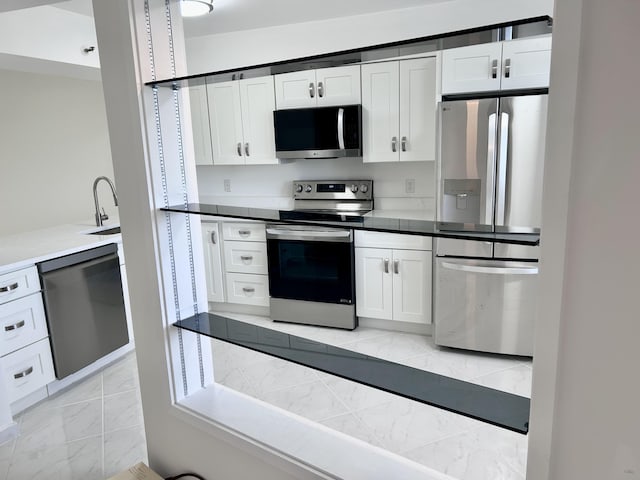 kitchen with white cabinets, stainless steel appliances, and sink