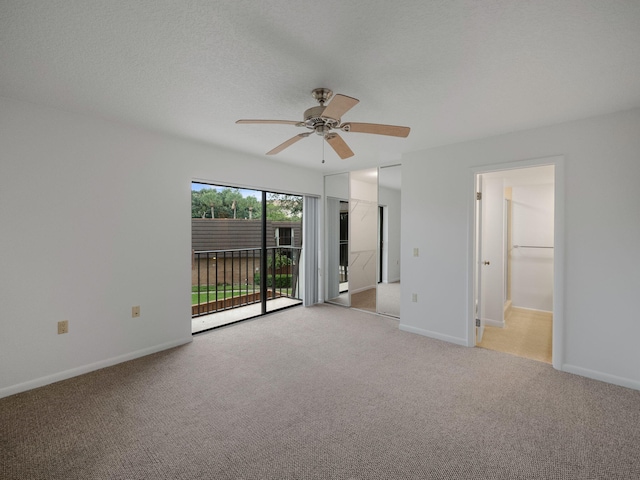 spare room with ceiling fan and light colored carpet